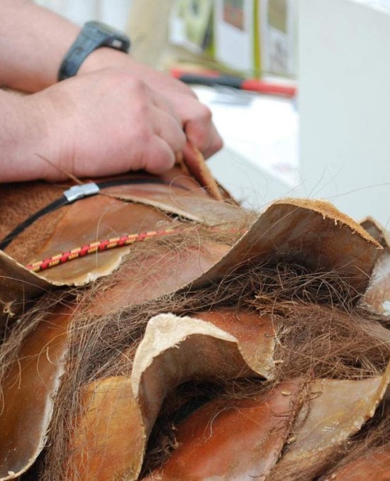 a person working on an artificial palm tree